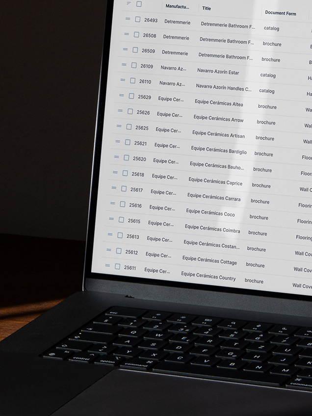 A product catalog spreadsheet open beside its source PDF, showing rows classified by category.